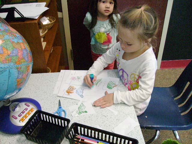 A girl coloring a picture of a dinosaur.